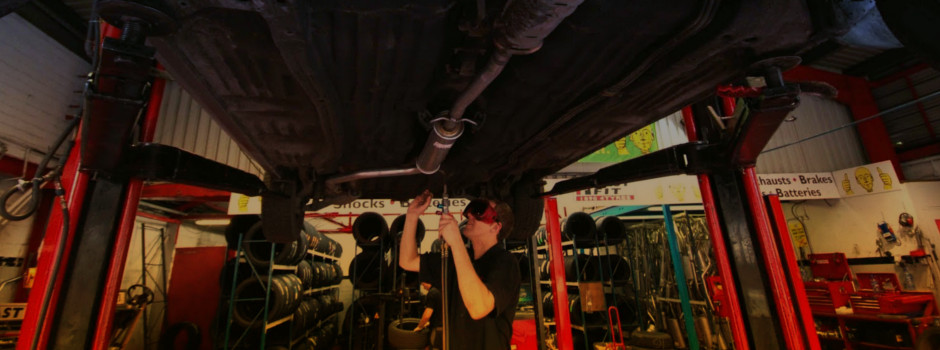 Mechanic holding a wrench at a car garage