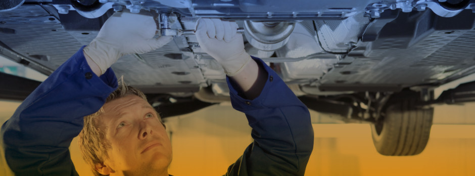 Mechanic holding a wrench at a car garage