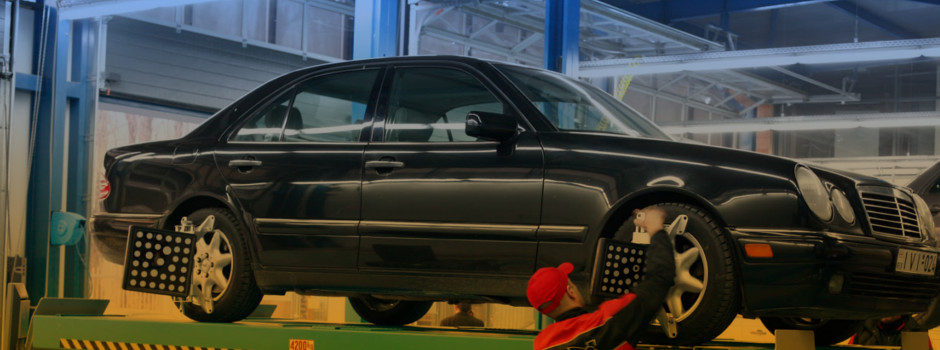 Mechanic holding a wrench at a car garage