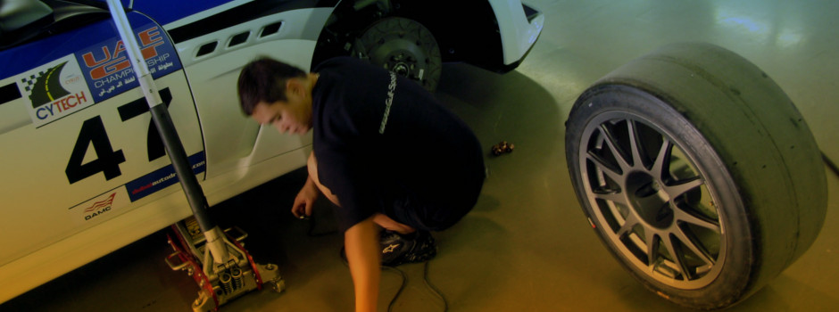 Mechanic holding a wrench at a car garage
